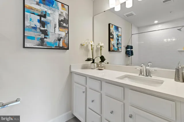 a bathroom with a double vanity sink and a mirror