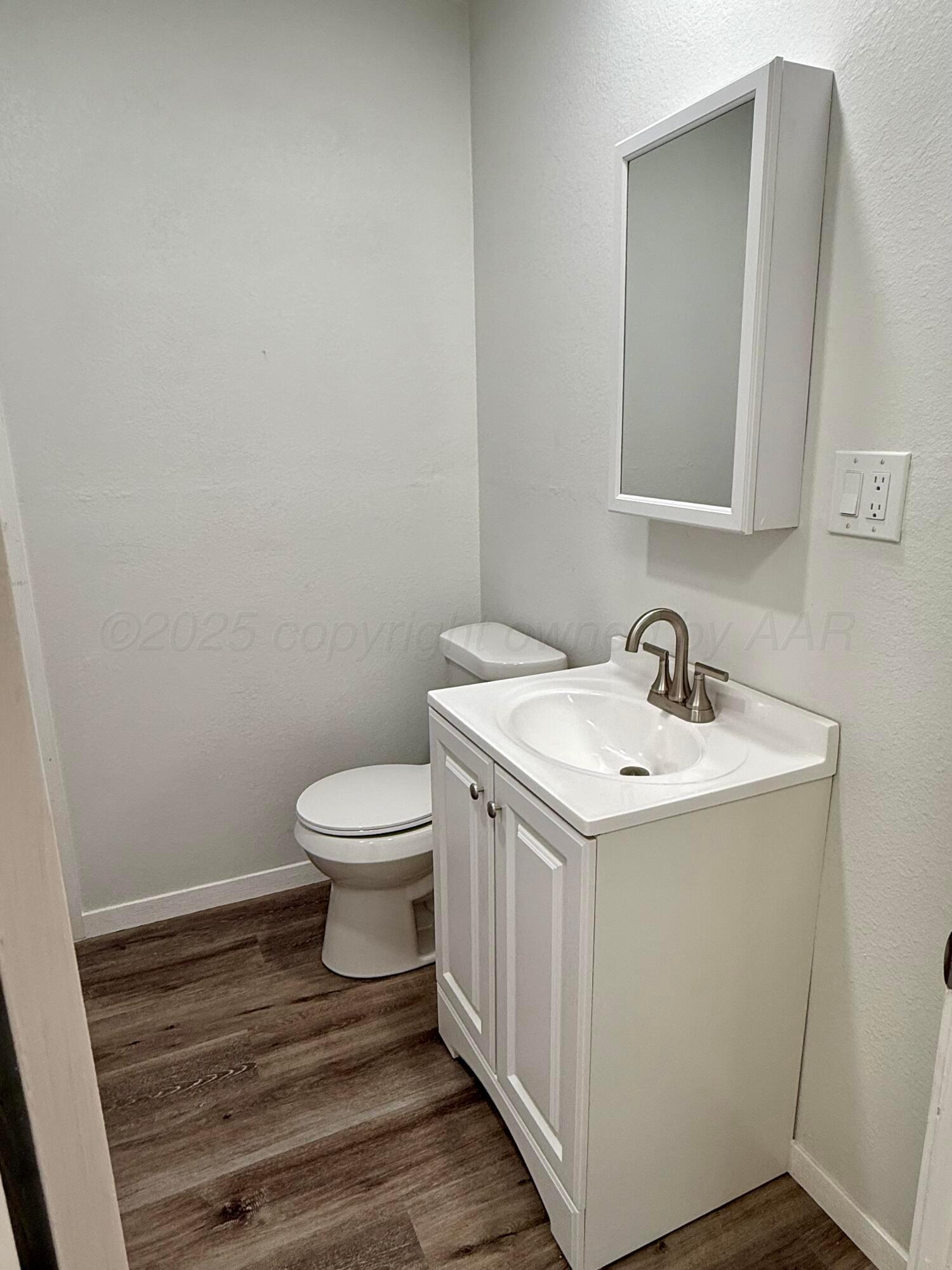 1303 Boyd Street Borger, TX 79007 - Photo 11 of 19 a bathroom with a toilet sink and mirror