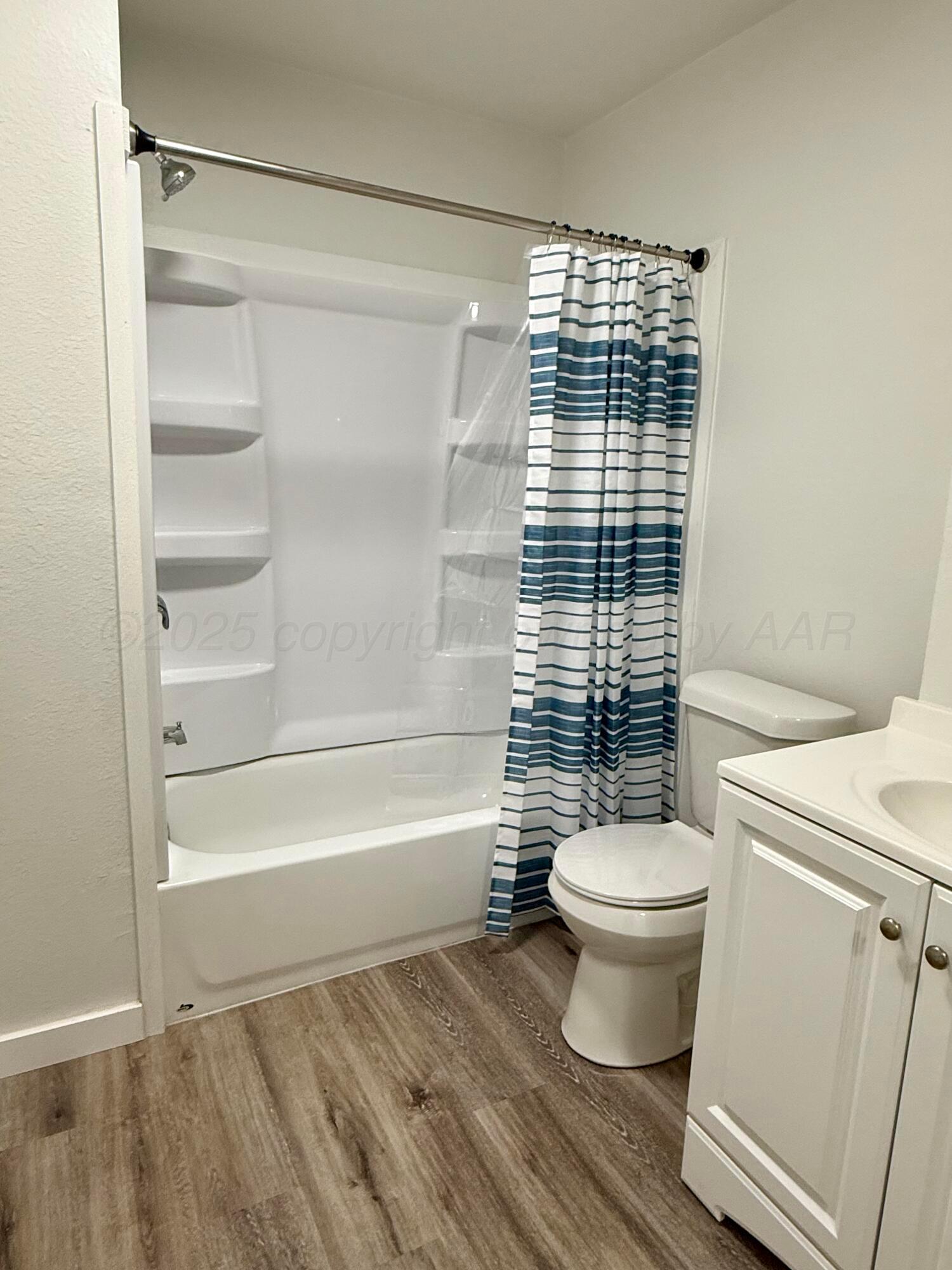 1303 Boyd Street Borger, TX 79007 - Photo 18 of 19 a bathroom with a toilet and a shower