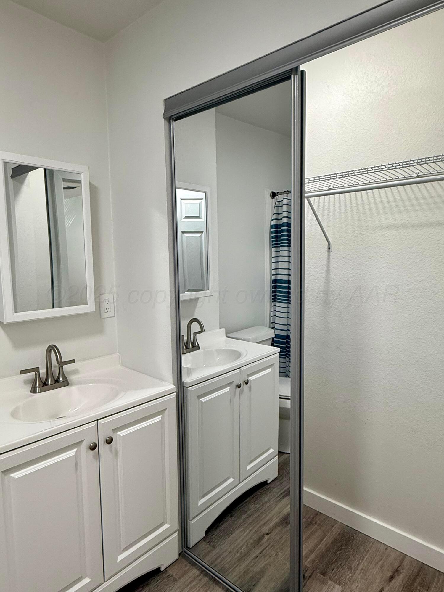 1303 Boyd Street Borger, TX 79007 - Photo 19 of 19 a bathroom with a sink and mirror