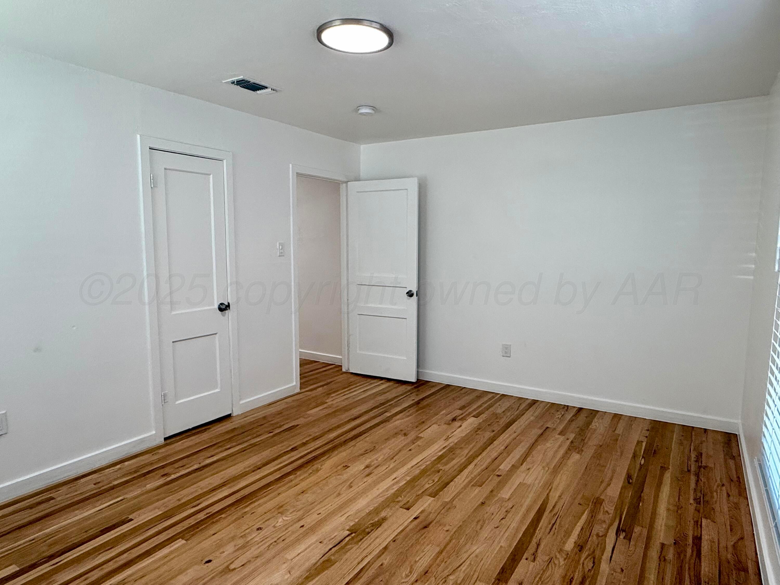 1303 Boyd Street Borger, TX 79007 - Photo 10 of 19 a view of an empty room and wooden floor