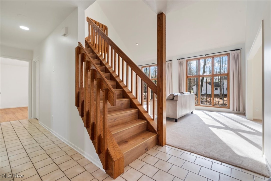 3520 Hunting Run Road Medina, OH 44256 - Photo 8 of 47 Stairway featuring carpet flooring and a high ceiling