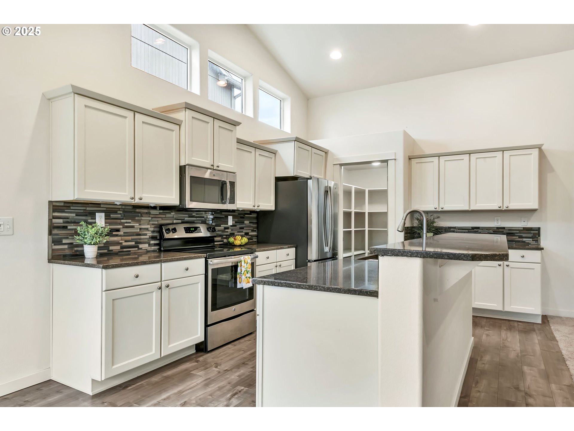3869 Gusty Avenue Northeast Albany, OR 97322 - Photo 7 of 47 a kitchen with stainless steel appliances granite countertop a stove a sink and a refrigerator