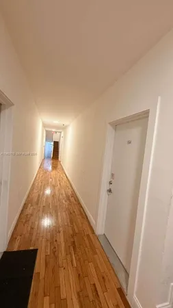 a view of wooden floor in an empty room
