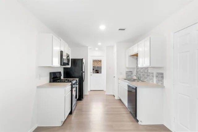 a kitchen with a refrigerator stove and microwave