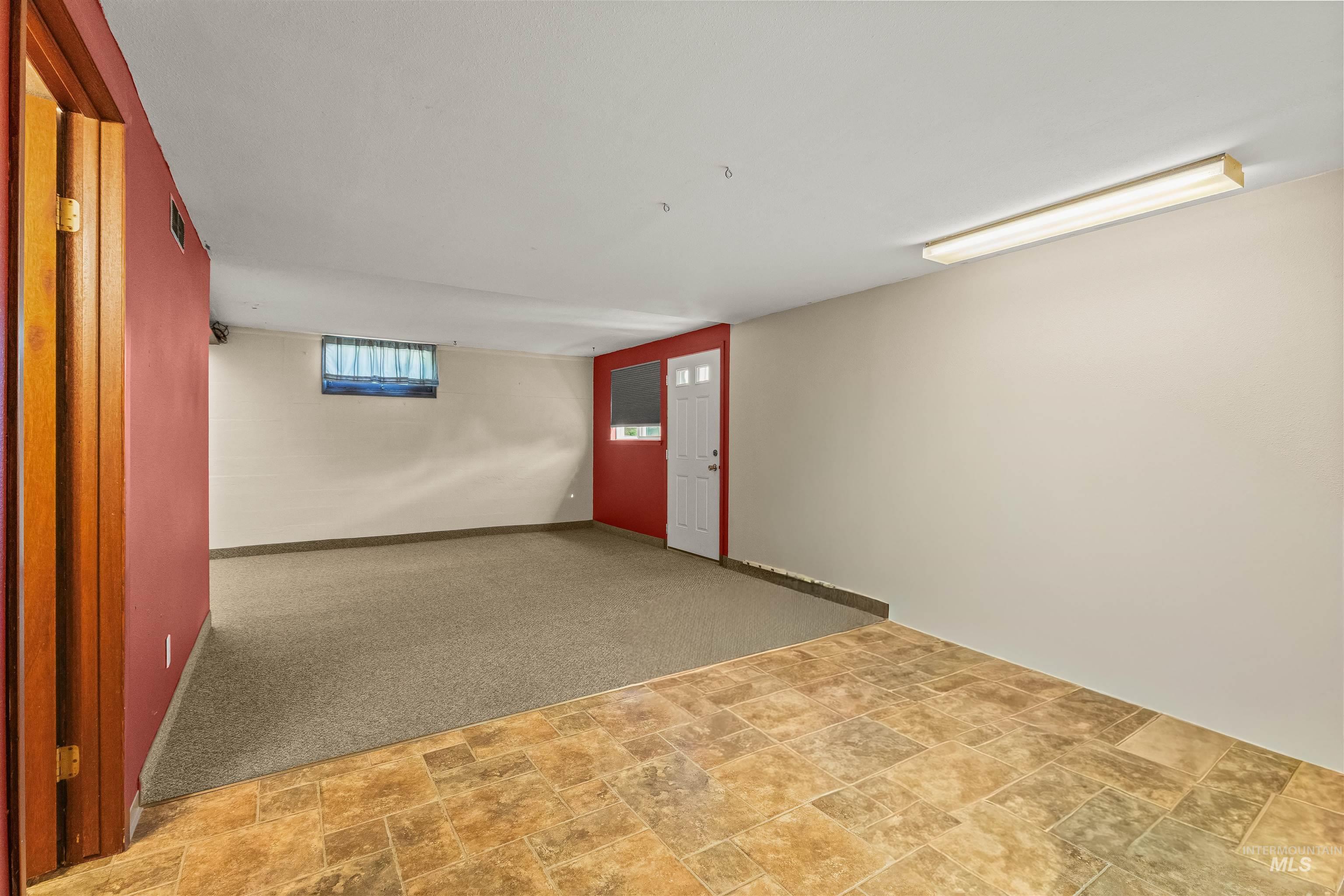 1663 9th Avenue Lewiston, ID 83501 - Photo 24 of 36 Spacious lower level featuring a combination of neutral carpet and patterned tile flooring