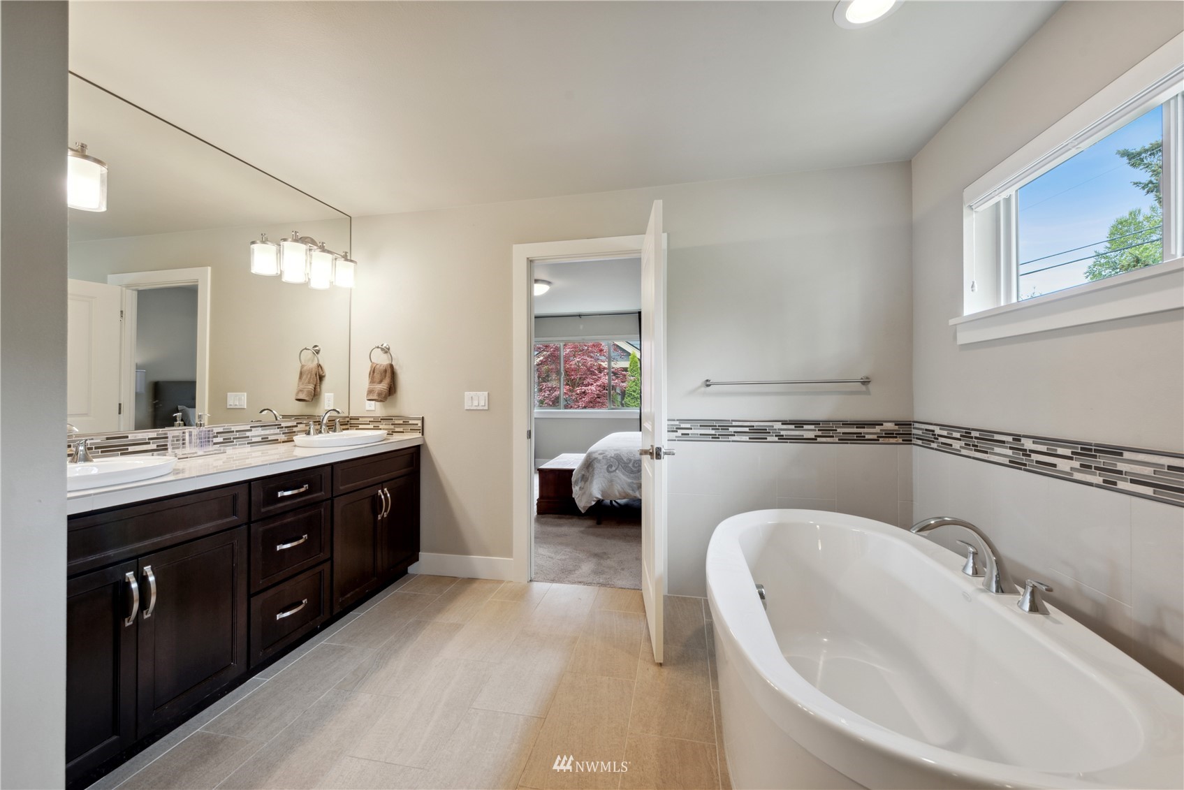24210 23rd Avenue West Bothell, WA 98021 - Photo 13 of 28 a en suite spacious bathroom with a double vanity sink double mirror and window