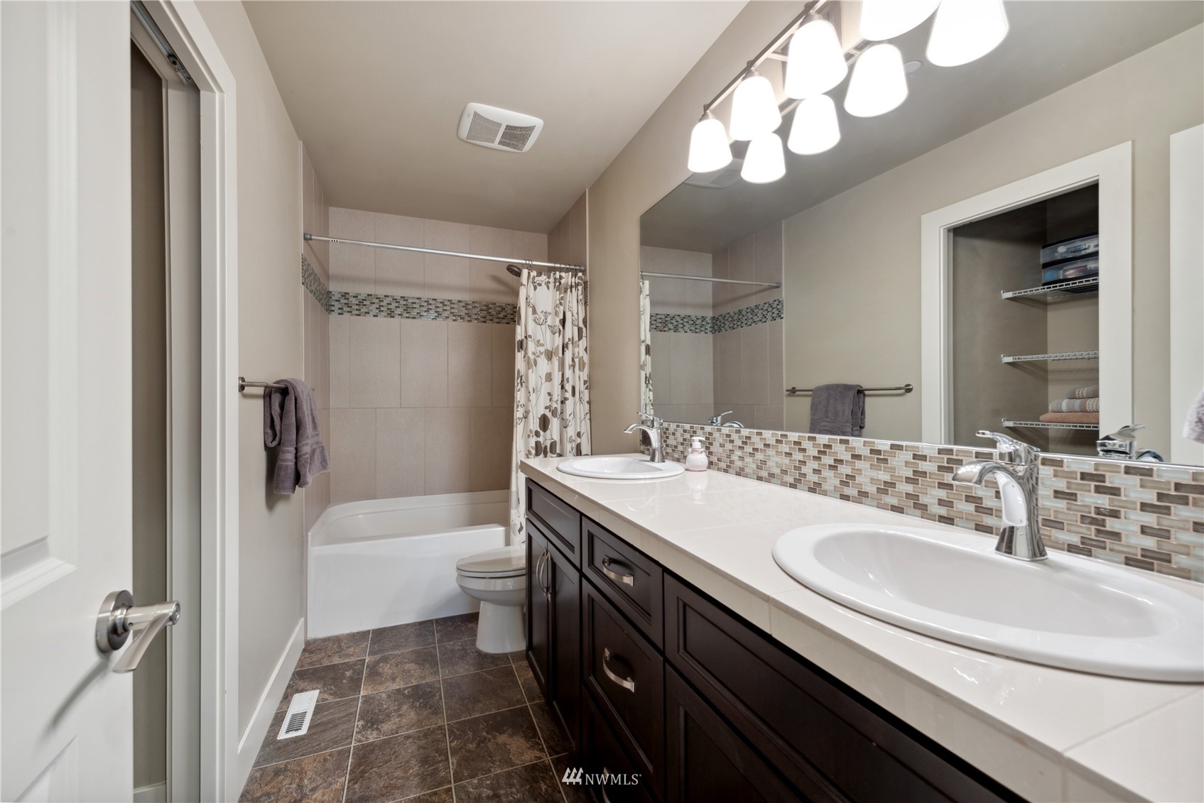 24210 23rd Avenue West Bothell, WA 98021 - Photo 17 of 28 a bathroom with a sink a toilet a mirror and shower