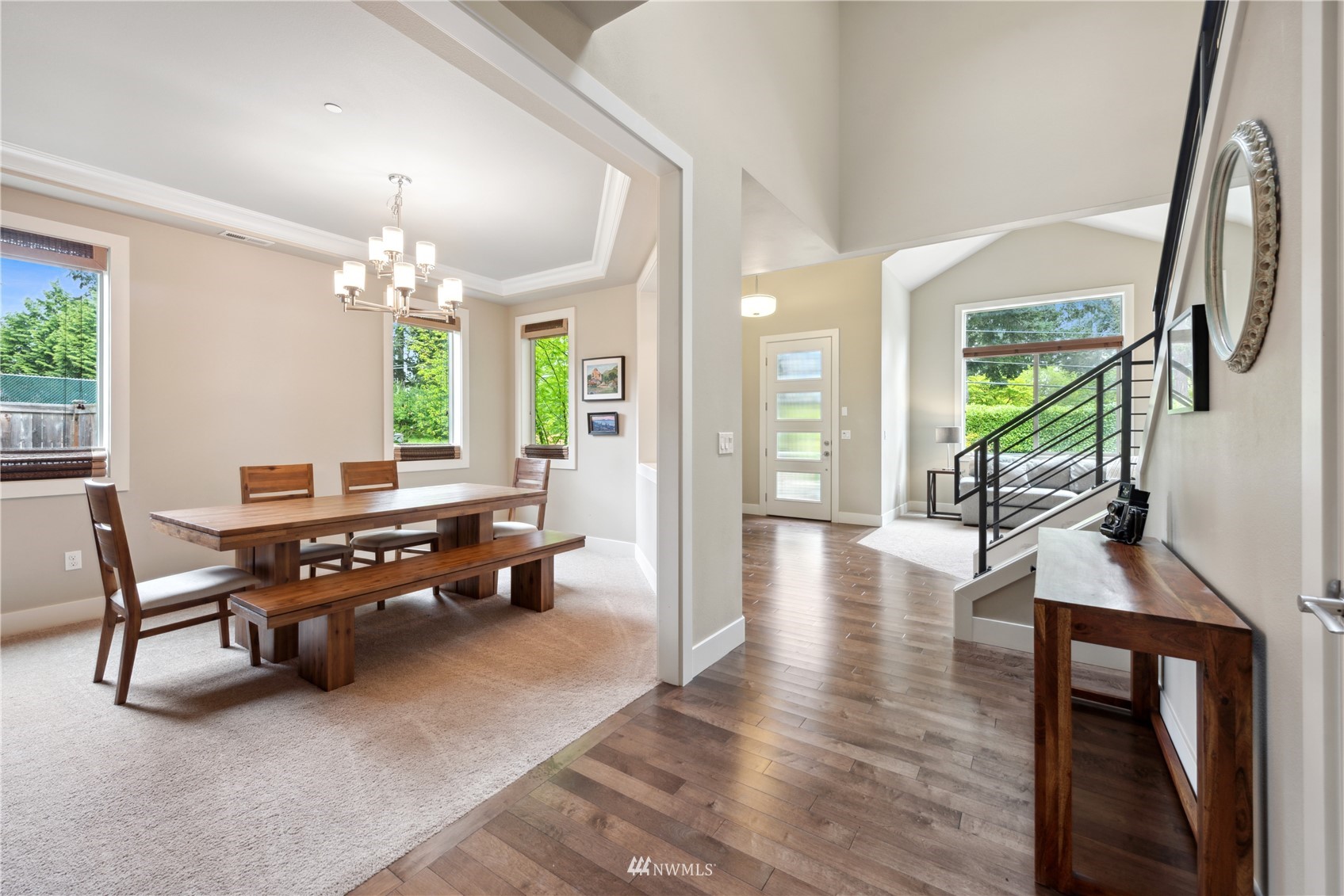 24210 23rd Avenue West Bothell, WA 98021 - Photo 4 of 28 a dining room with wooden floor a chandelier a wooden table and chairs