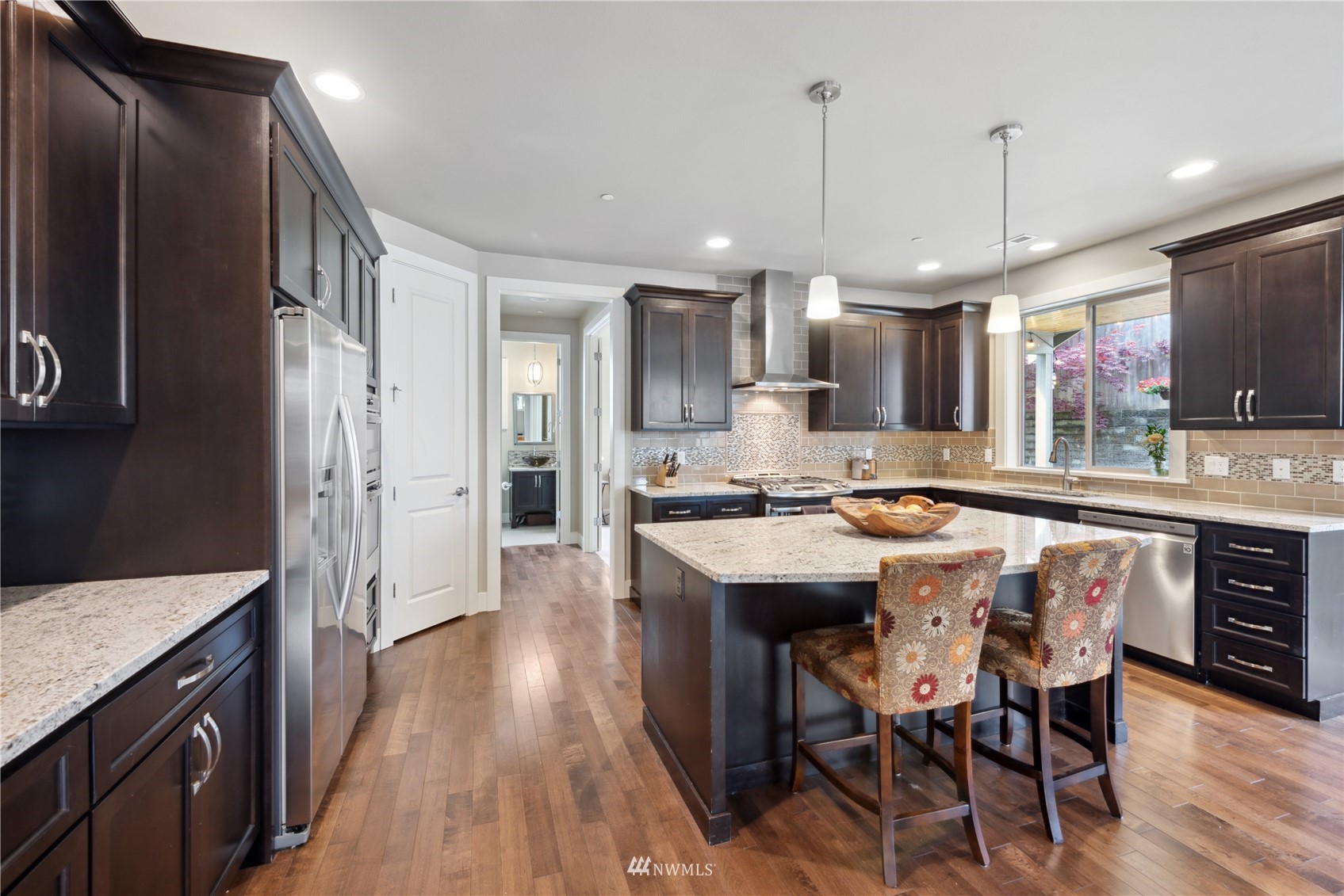 24210 23rd Avenue West Bothell, WA 98021 - Photo 7 of 28 a kitchen with granite countertop a sink appliances cabinets and wooden floor