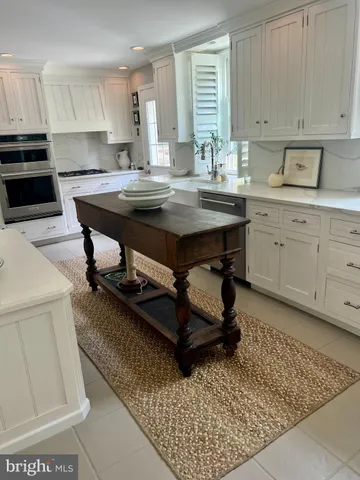 a kitchen with a sink appliances and cabinets