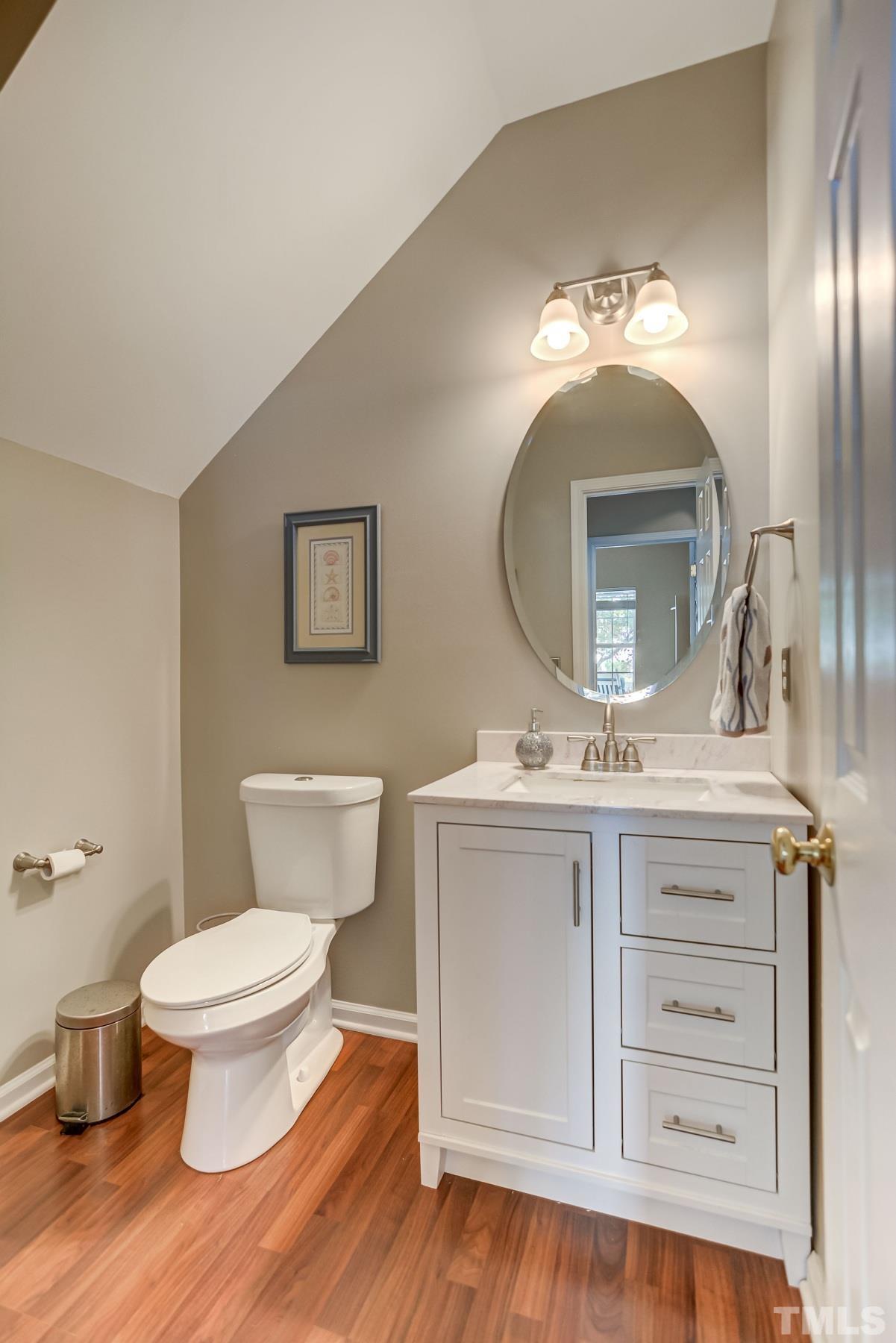 5424 Neuse Forest Road Raleigh, NC 27616 - Photo 14 of 30 a bathroom with a toilet sink and mirror
