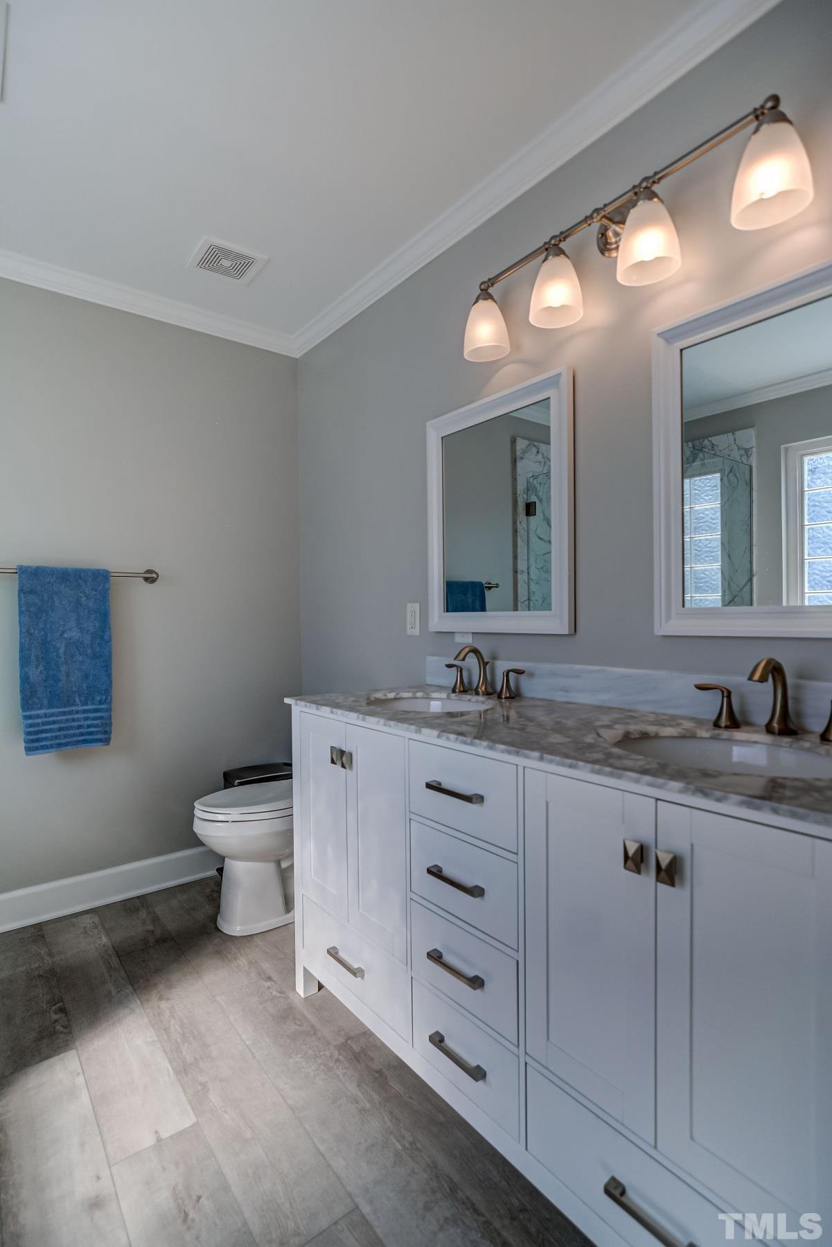 5424 Neuse Forest Road Raleigh, NC 27616 - Photo 17 of 30 a bathroom with a granite countertop toilet sink and mirror