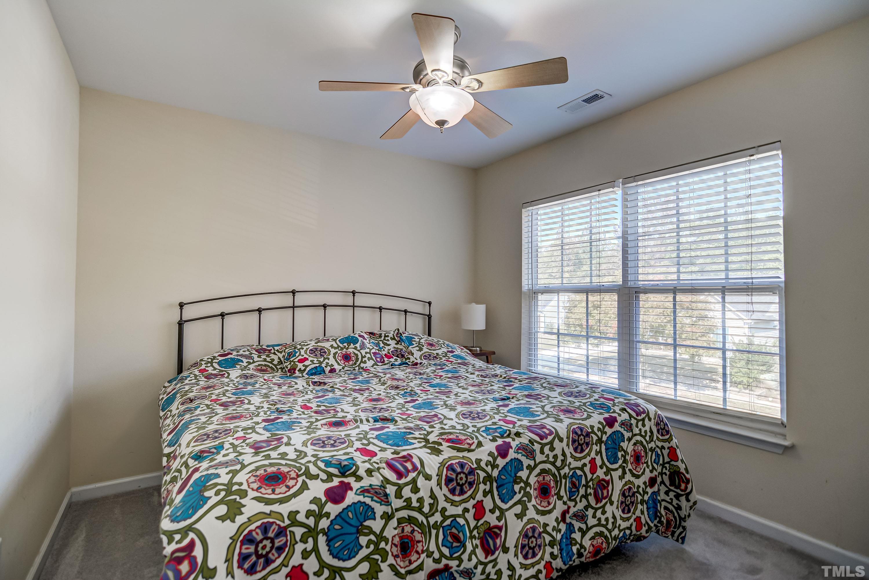 5424 Neuse Forest Road Raleigh, NC 27616 - Photo 21 of 30 a large bed sitting in a bedroom next to a window