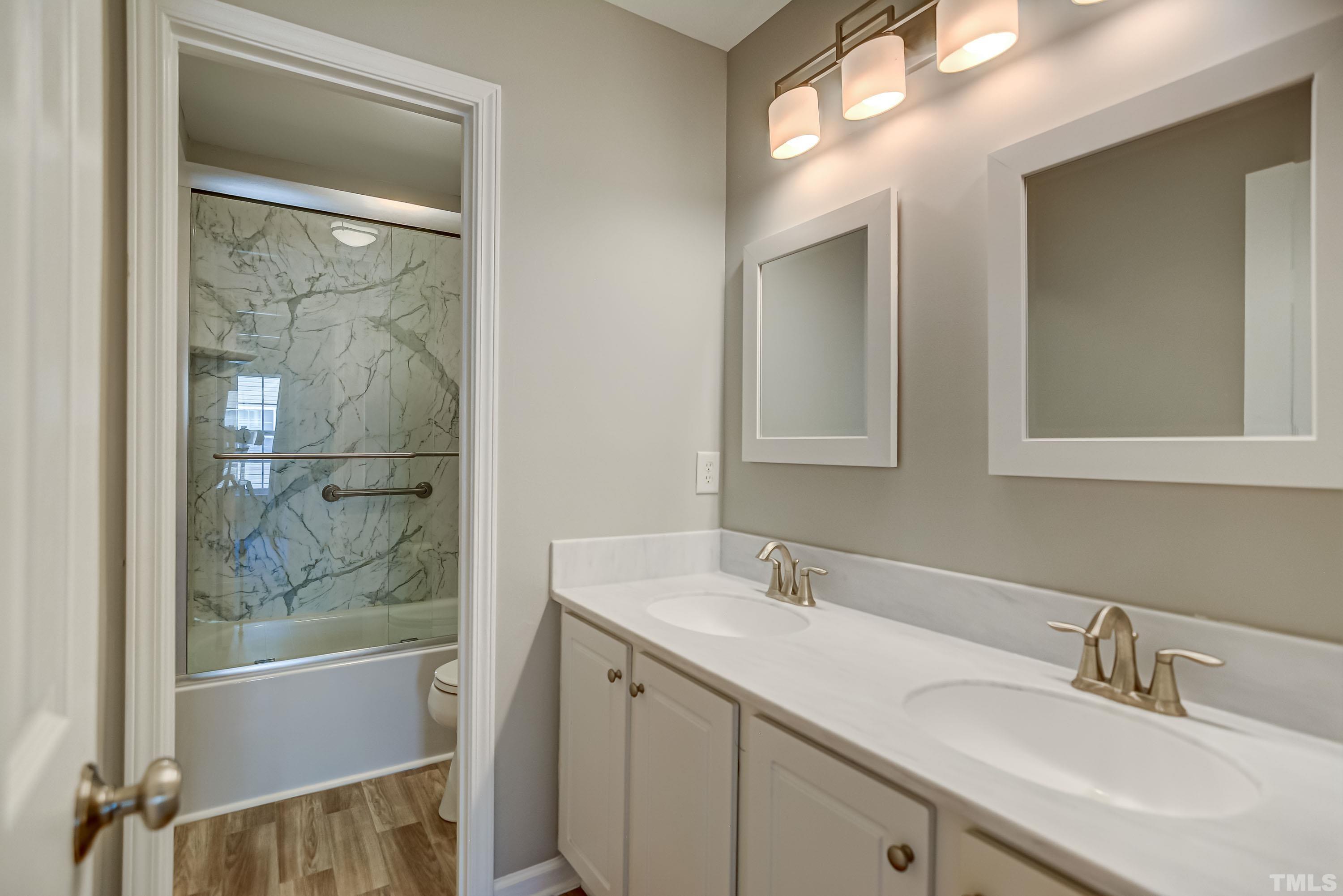 5424 Neuse Forest Road Raleigh, NC 27616 - Photo 23 of 30 a bathroom with a sink vanity tub and a mirror