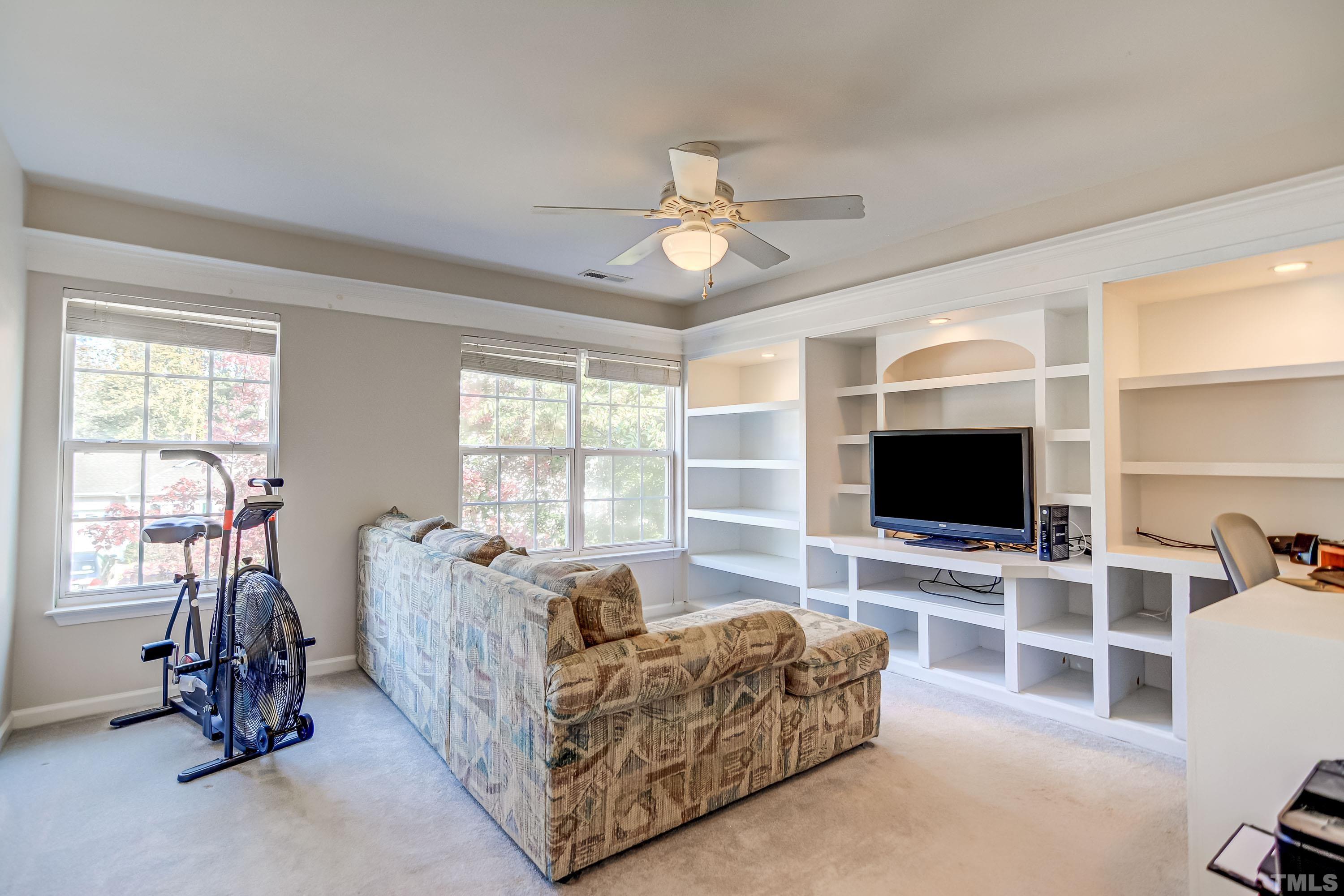 5424 Neuse Forest Road Raleigh, NC 27616 - Photo 25 of 30 a living room with furniture a flat screen tv and a large window