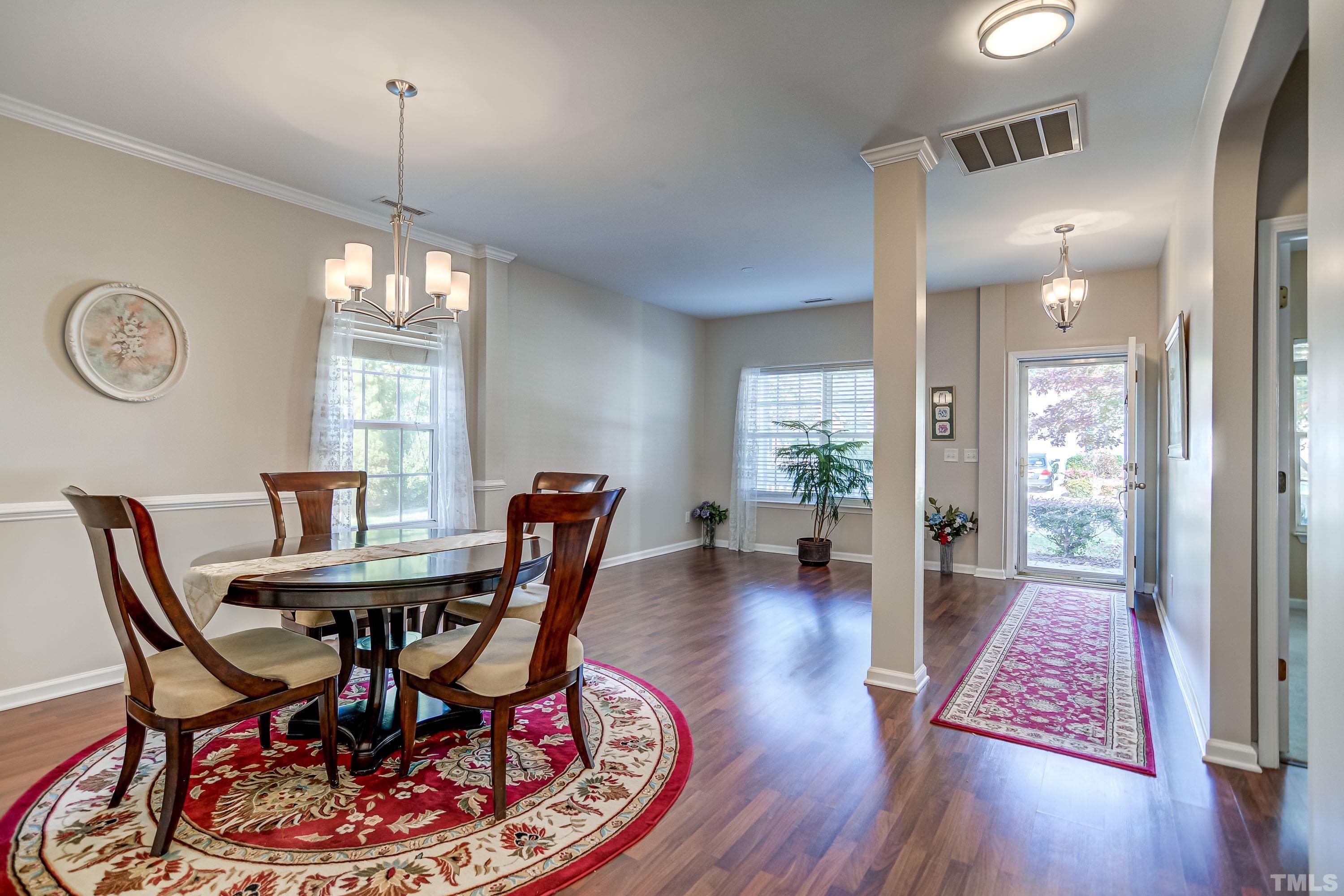 5424 Neuse Forest Road Raleigh, NC 27616 - Photo 3 of 30 a view of a dining room with furniture window and wooden floor