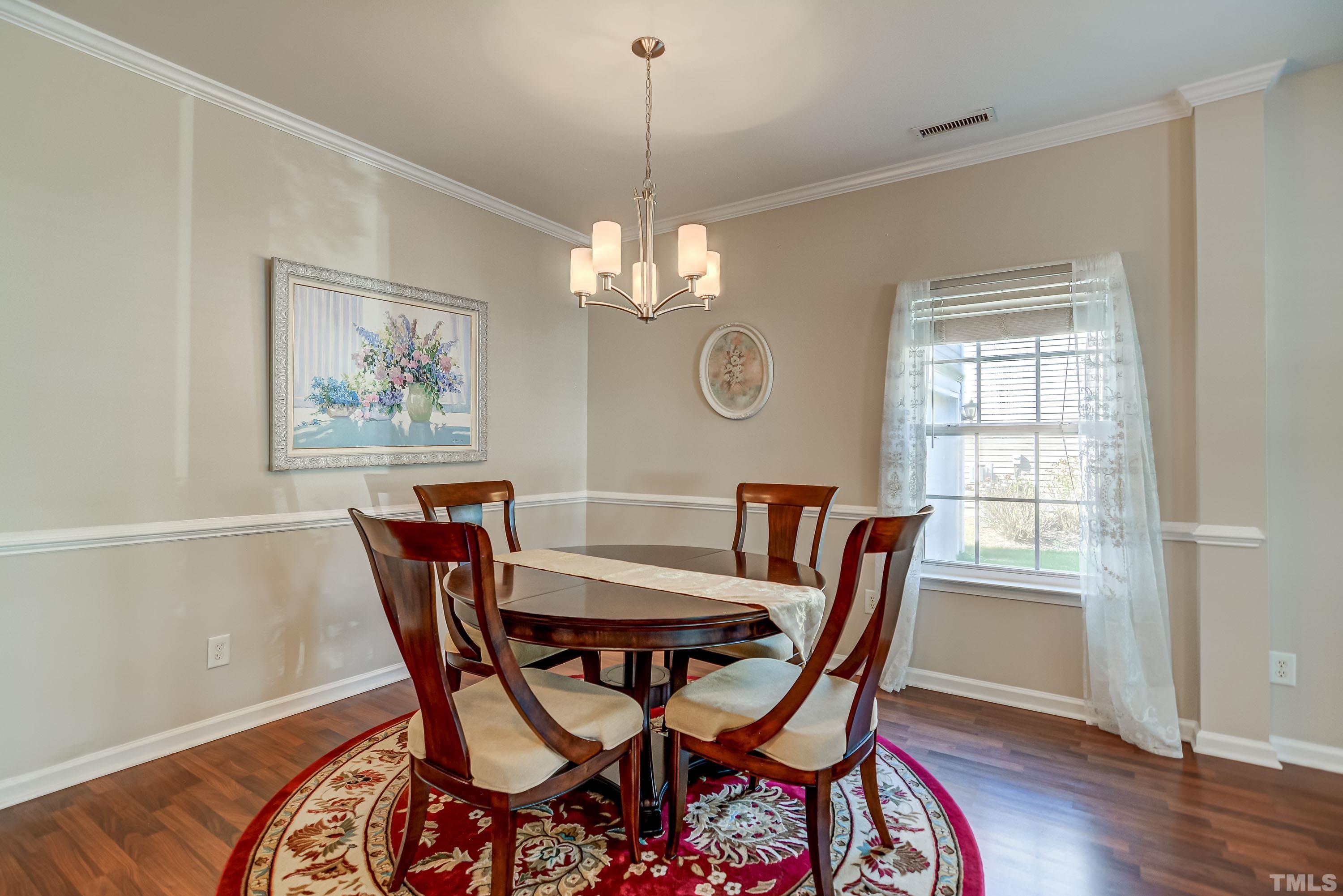 5424 Neuse Forest Road Raleigh, NC 27616 - Photo 6 of 30 a view of a dining room with furniture window and wooden floor