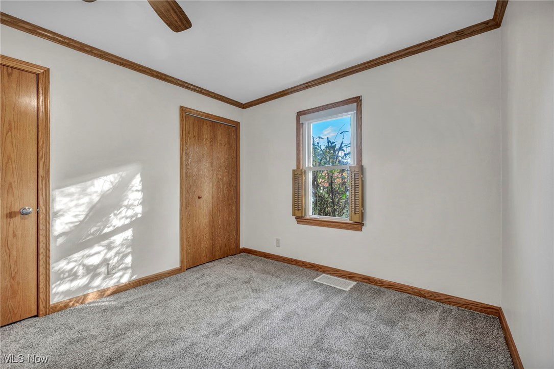 503 Churchill Road Youngstown, OH 44505 - Photo 12 of 32 Bedroom 3 with ornamental molding, a closet, carpet flooring, and ceiling fan