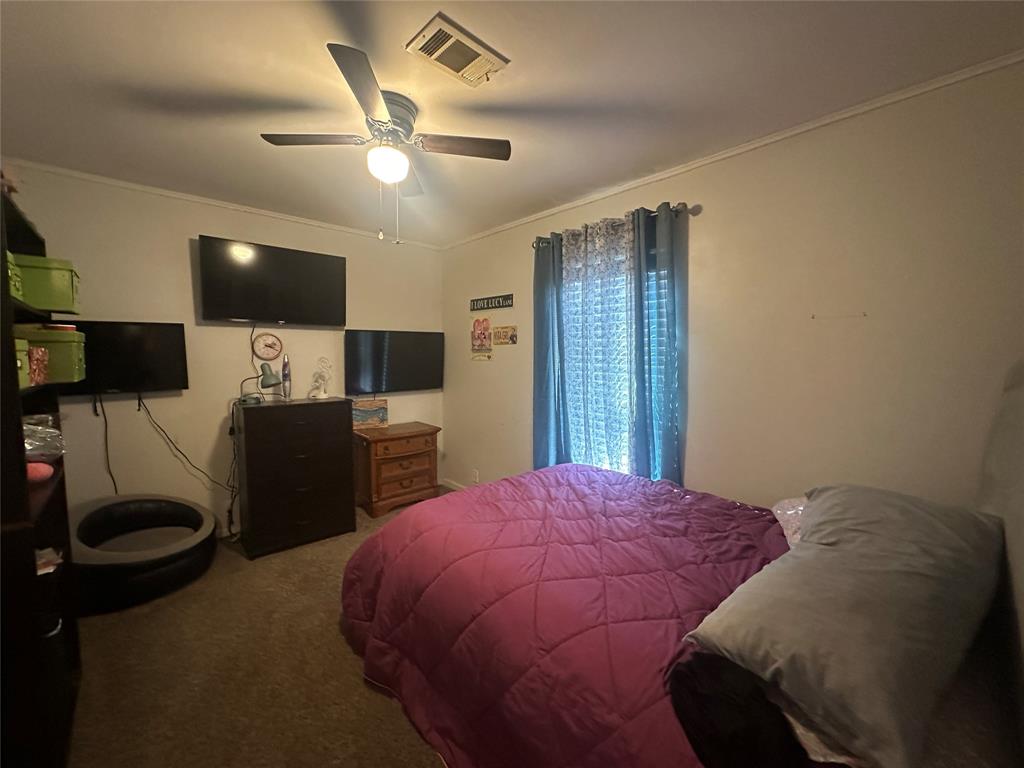 2620 North State Highway 37 Quitman, TX 75783 - Photo 21 of 27 a bedroom with a bed and a flat screen tv