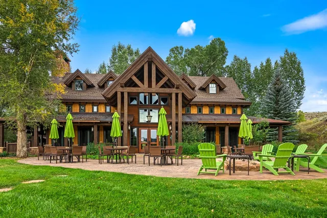 a front view of a house with a yard and potted plants