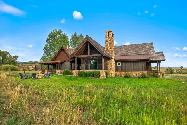 a view of a chairs and table in patio with wooden floor