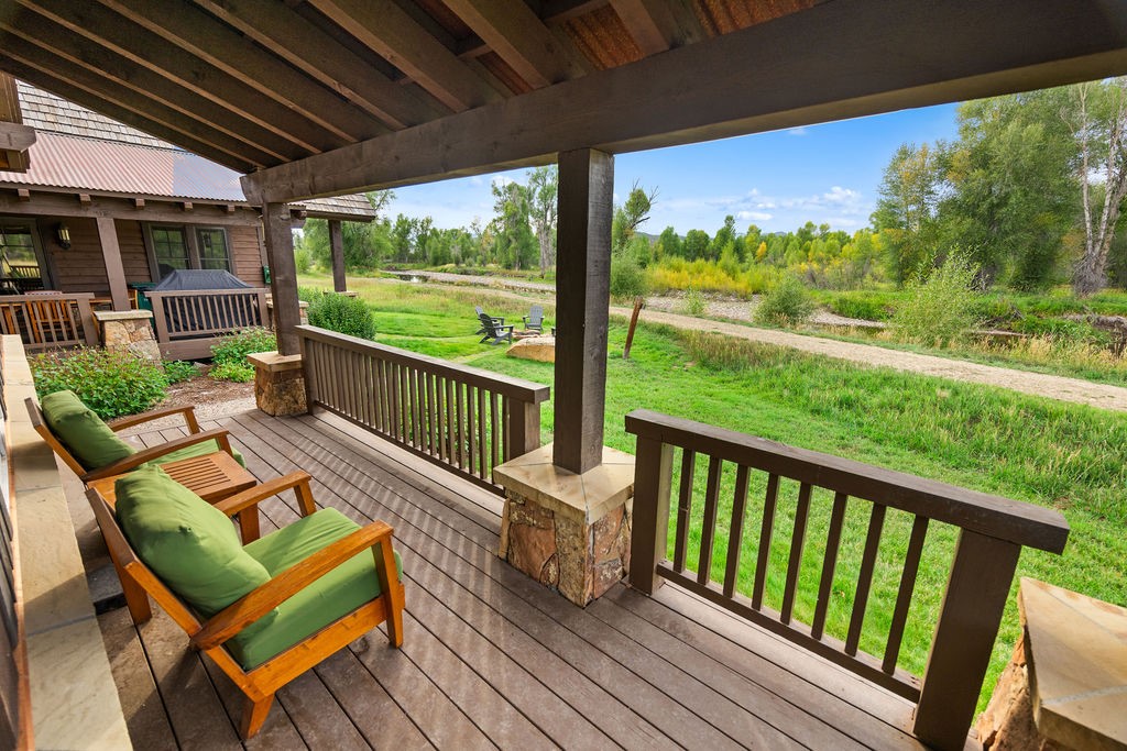 27095 Fire Song Road Steamboat Springs, CO 80487 - Photo 16 of 39 a view of a chairs and table in patio with wooden floor