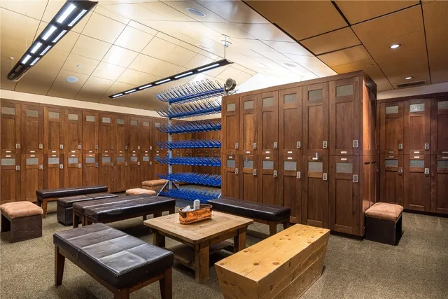 a living room with fireplace furniture and a large window