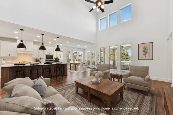 a living room with furniture kitchen view and a table