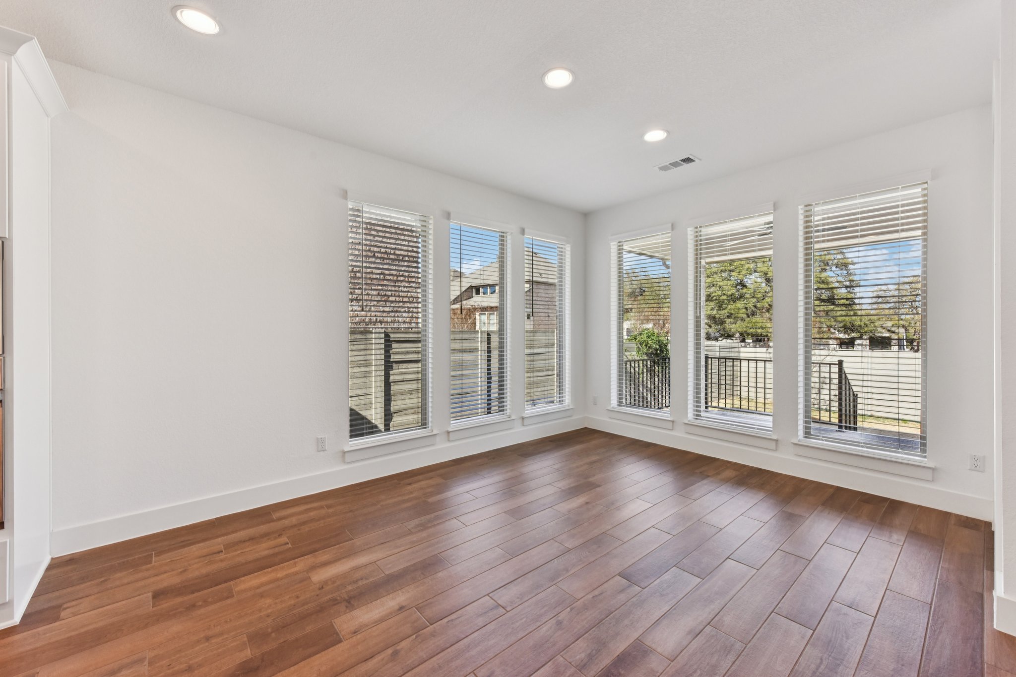 225 Ashmore Lane Georgetown, TX 78628 - Photo 9 of 36 Dining area is surrounded by floor to celing windows, Large enough for holiday dinners. Notice no direct house behind the windows, just a beautiful tree!