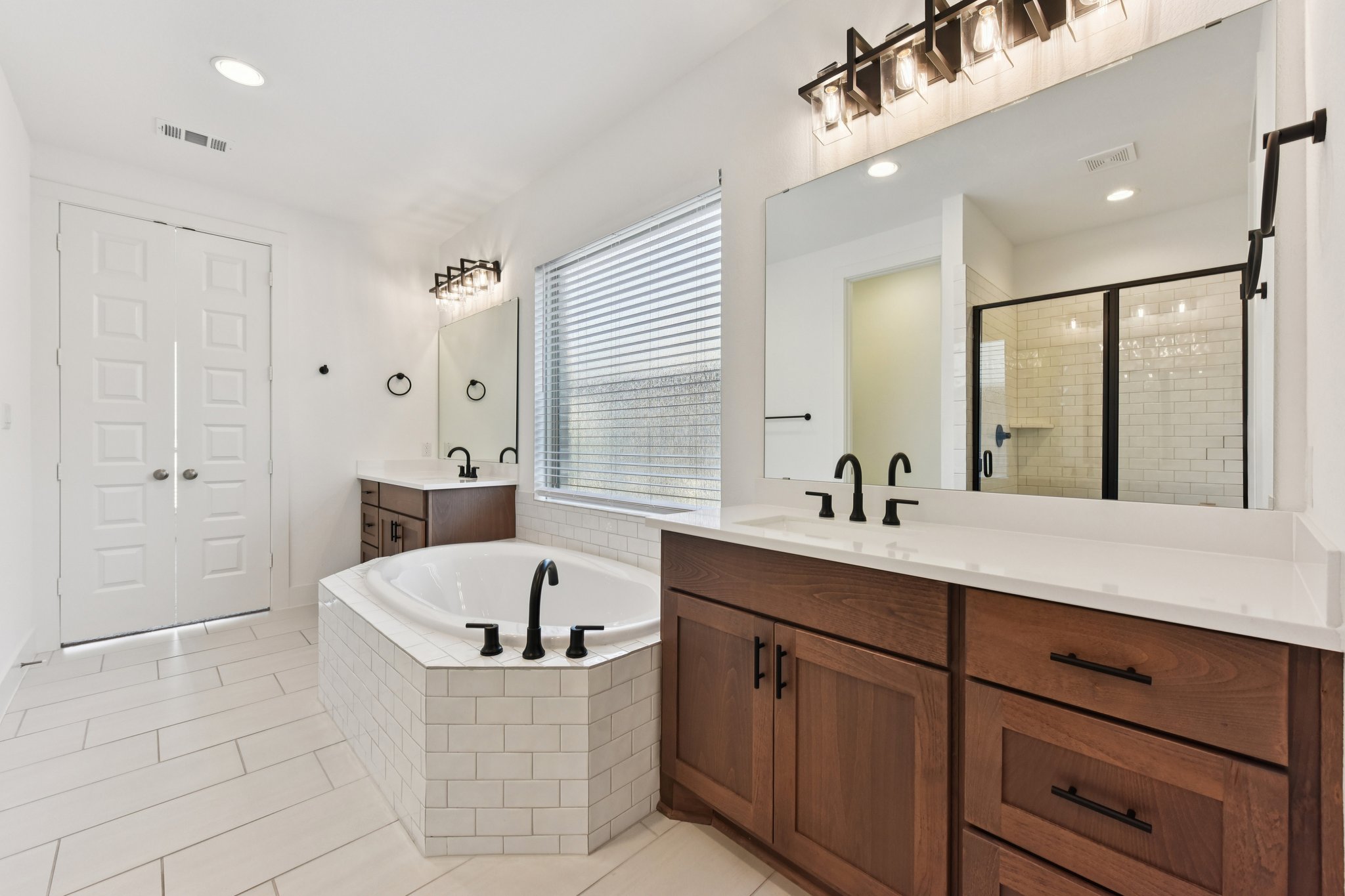 225 Ashmore Lane Georgetown, TX 78628 - Photo 14 of 36 Stunning spa like primary bathroom will help getting ready so much more enjoyable. Double sinks with plenty of storage options and a refreshing separate shower.