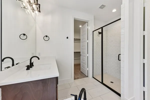 a bathroom with a tub sink and mirror