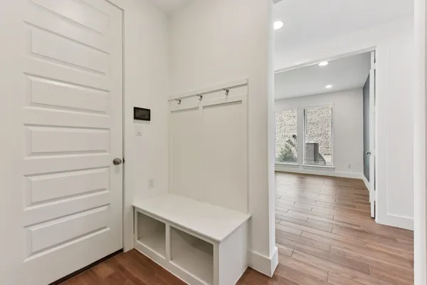 a room with a table chairs and wooden floor