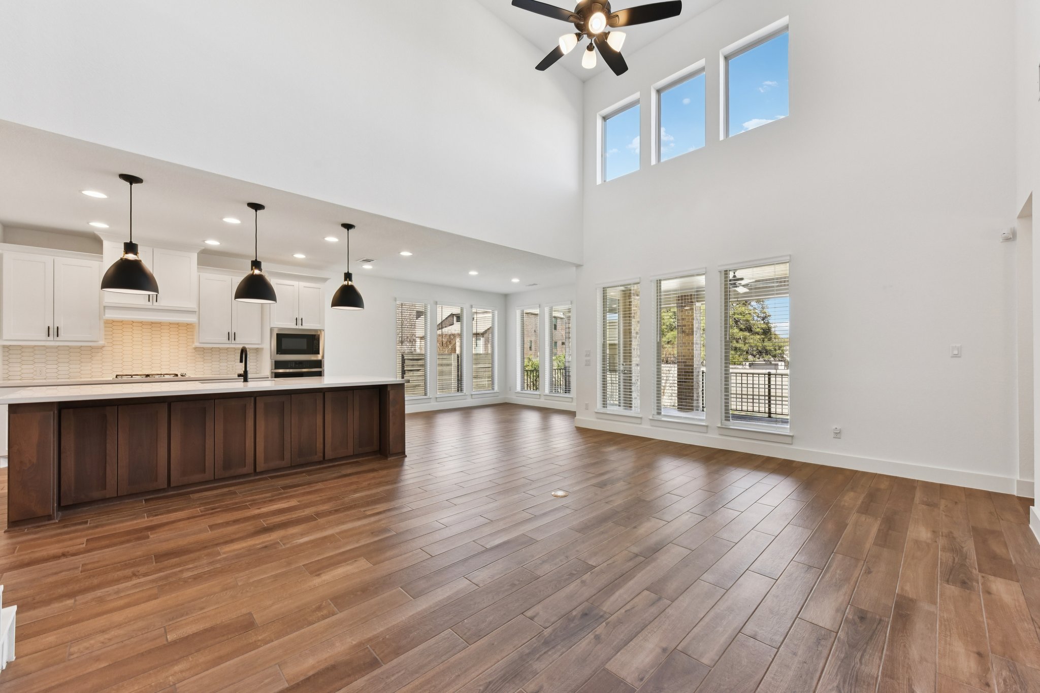 225 Ashmore Lane Georgetown, TX 78628 - Photo 3 of 36 Floor to ceiling windows provide an abundance of natural light. Gorgeous wood look tile floors for easy living for a busy family