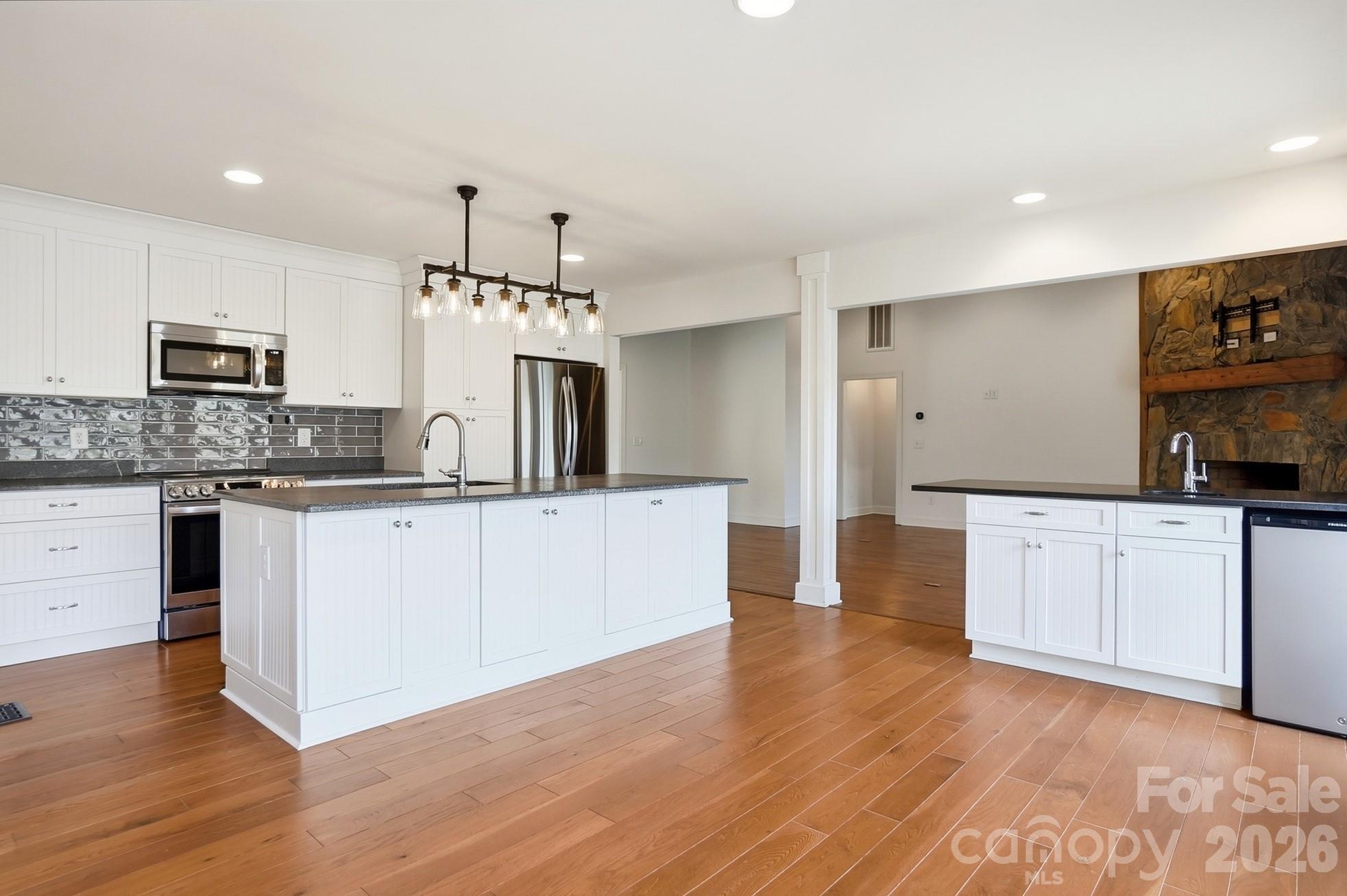2295 Sussex Road York, SC 29745 - Photo 17 of 47 a large kitchen with cabinets wooden floor and stainless steel appliances