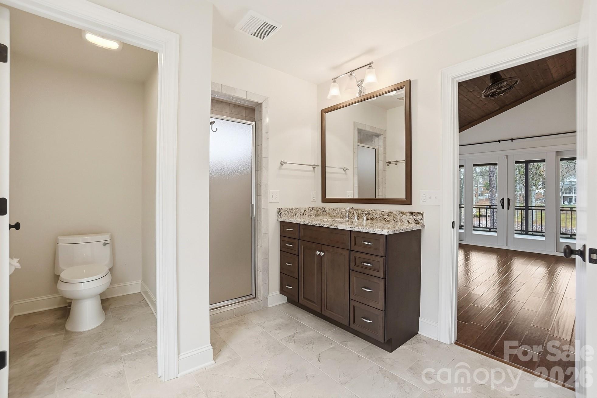 2295 Sussex Road York, SC 29745 - Photo 21 of 47 a spacious bathroom with a granite countertop sink mirror and toilet