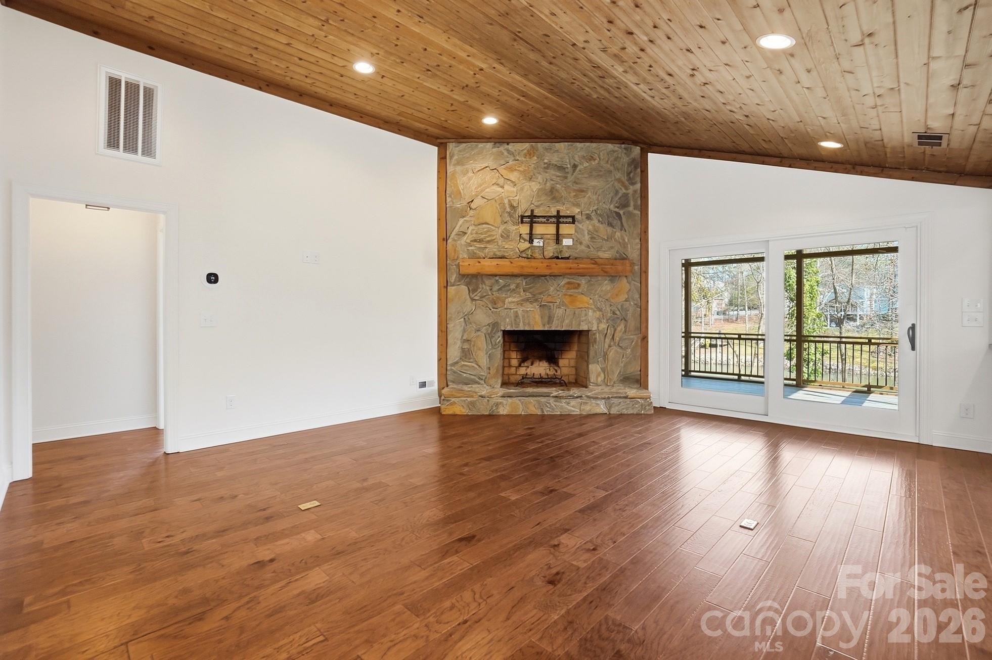 2295 Sussex Road York, SC 29745 - Photo 8 of 47 an empty room with wooden floor fireplace and windows