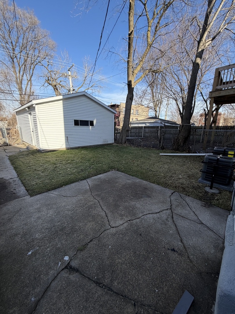 1048 West Marquette Road, Unit 1 Chicago, IL 60621 - Photo 12 of 13 a front view of a house with a yard and garage