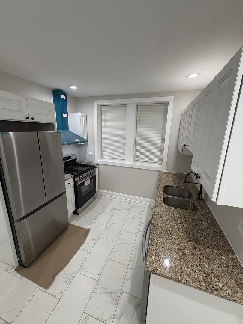 1048 West Marquette Road, Unit 1 Chicago, IL 60621 - Photo 10 of 13 a kitchen with a sink a stove and refrigerator
