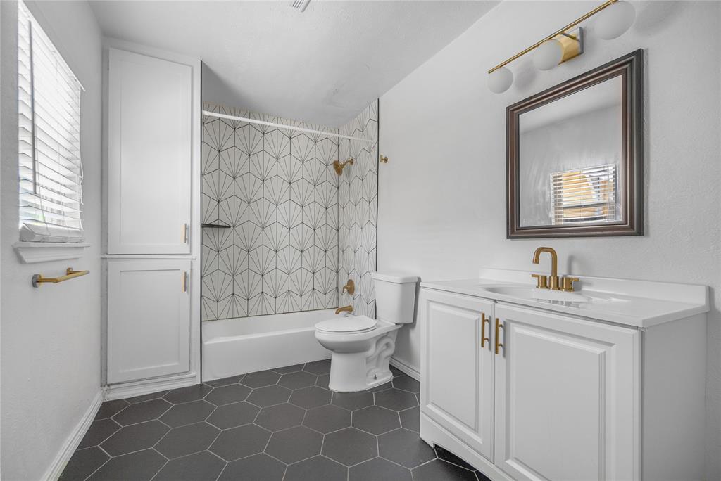 4723 Victor Street, Unit B Dallas, TX 75246 - Photo 8 of 12 Bathroom featuring a white vanity with gold-tone hardware, a rectangular sink, and a white countertop