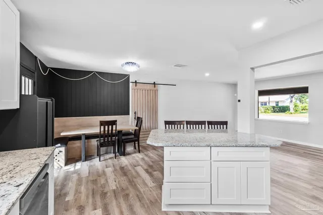 a balcony with table and chairs