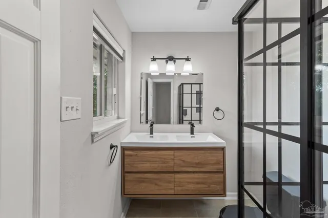 a bathroom with a sink a vanity and a large mirror