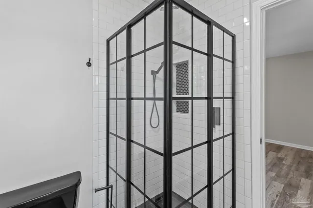 a bathroom with a glass shower door