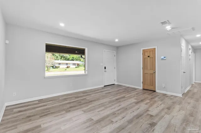 a kitchen with kitchen island granite countertop a sink stove and refrigerator