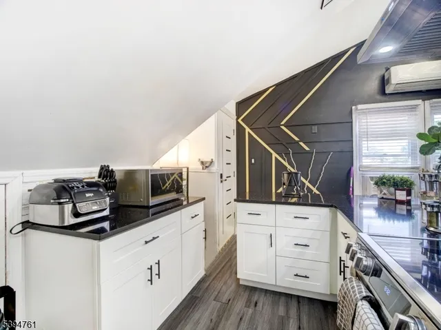 a kitchen that has a sink and a stove with white countertops