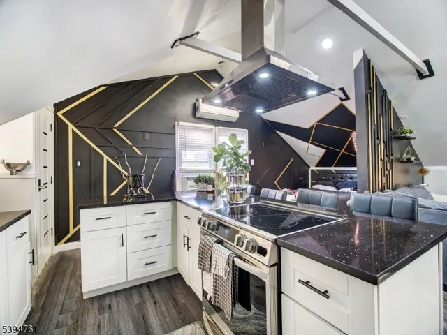 a kitchen with stainless steel appliances granite countertop a sink a stove and a refrigerator