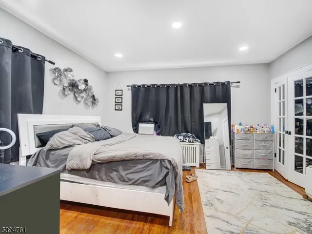 a bed sitting in a bedroom and kitchen