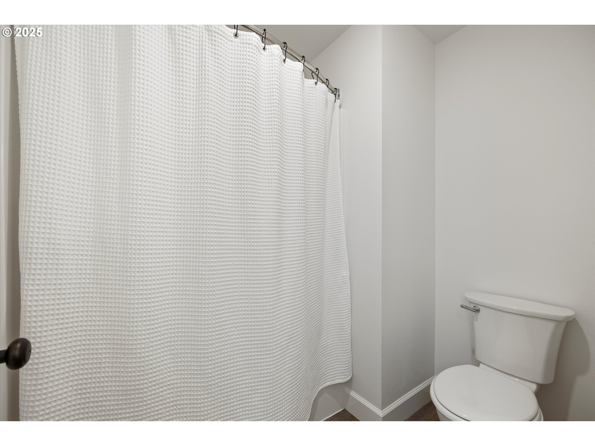 1678 Wilson Street Umatilla, OR 97882 - Photo 31 of 38 a bathroom with a toilet and a shower curtain