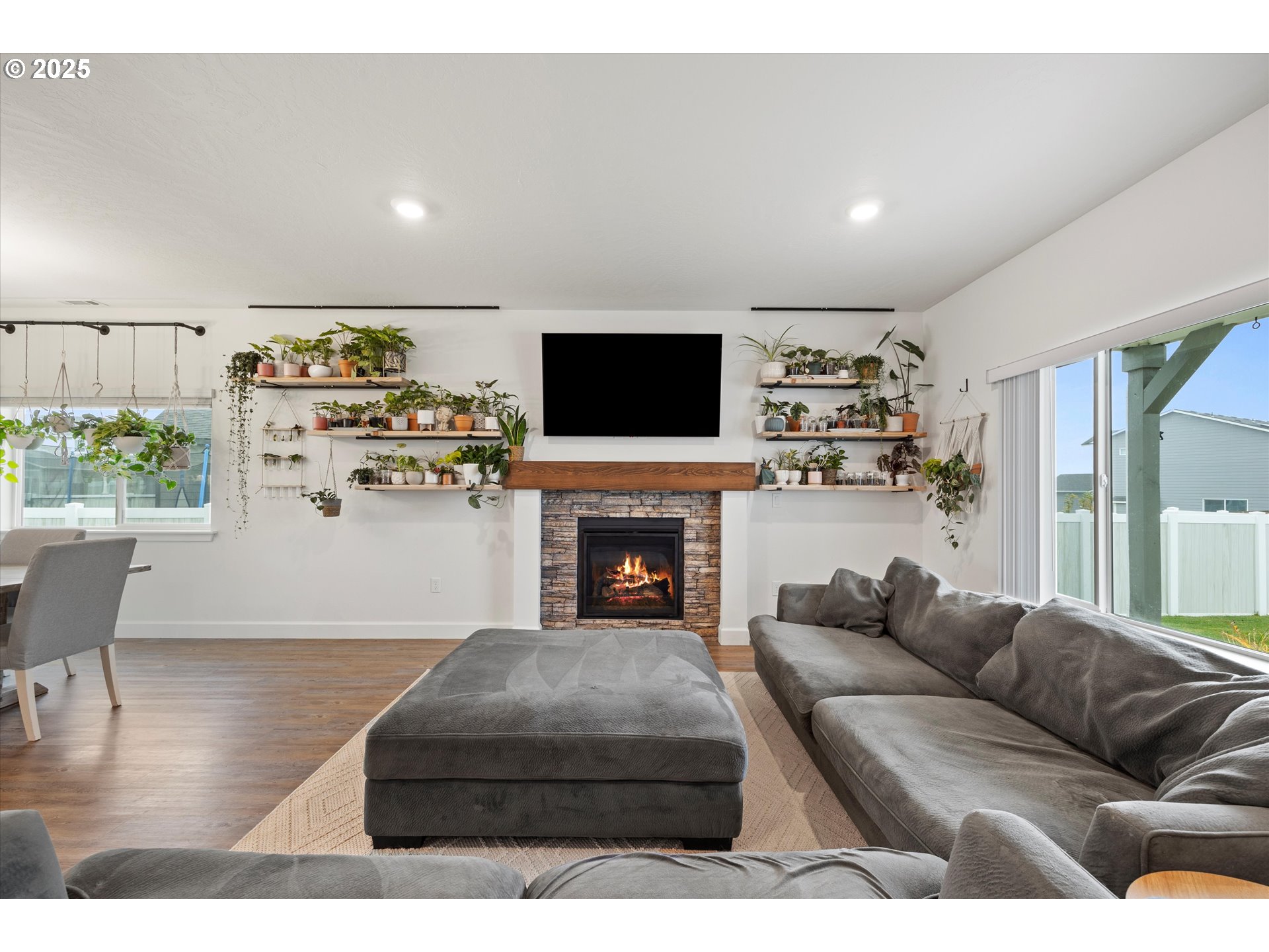 1678 Wilson Street Umatilla, OR 97882 - Photo 5 of 38 a living room with furniture a fireplace and a flat screen tv