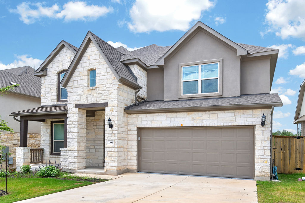 1332 Ridge Runner Drive Georgetown, TX 78628 - Photo 2 of 40 A striking facade with varied textures presents a welcoming curb appeal and a spacious attached garage.